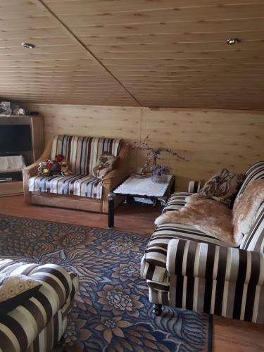 a living room with two couches and a table at Home Jurmala in Jūrmala