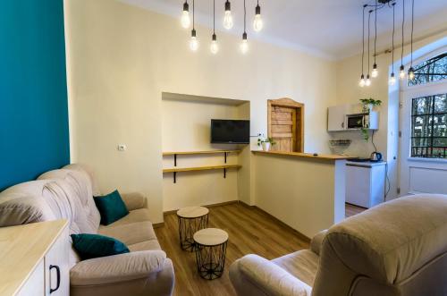 a living room with two couches and a kitchen at Apartament Żychoniówka in Zakopane