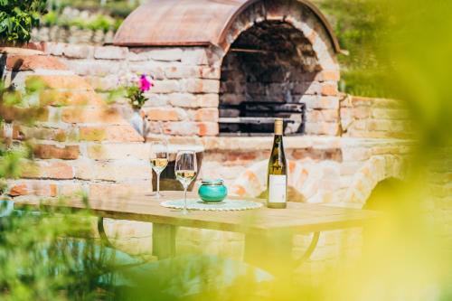 a table with a bottle of wine and two glasses at Wachau-Living in Dürnstein