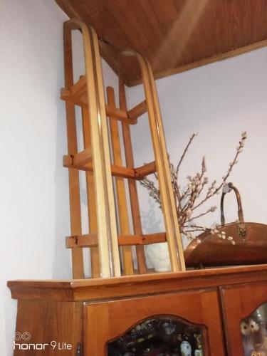 two wooden chairs sitting on top of a cabinet at CHALET Tout Confort Proche d AX 3 Domaines in Vèbre