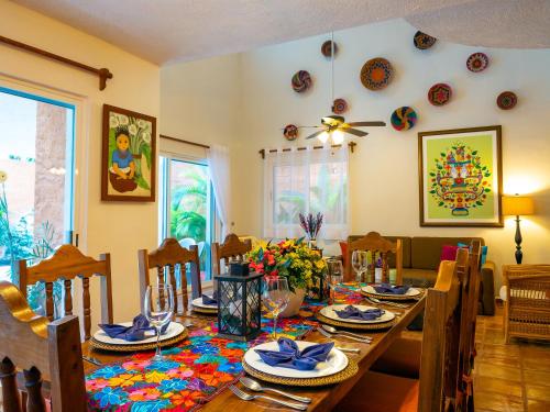 a dining room with a wooden table and chairs at Casa Mulder - Steps to Beach Private Pool Ocean-View Roof in Puerto Morelos