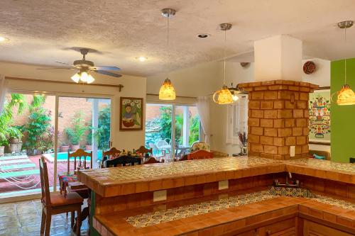 a kitchen with a fireplace and a dining room at Casa Mulder - Steps to Beach Private Pool Ocean-View Roof in Puerto Morelos