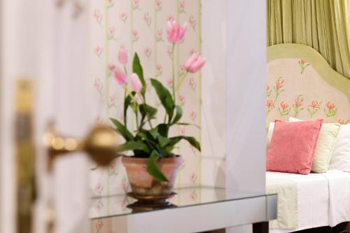 a potted plant on a glass table next to a couch at Casa de Sao Mamede Hotel in Lisbon
