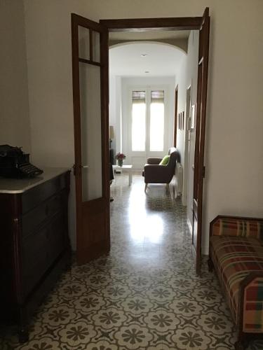 a room with a door open to a living room at El Llimoner in Banyoles