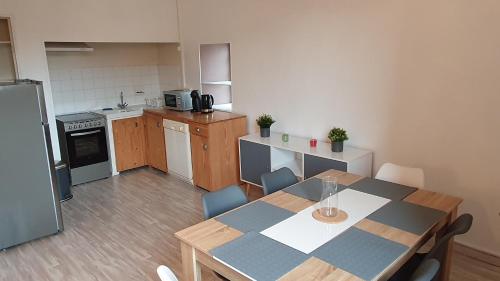 a kitchen with a table and chairs in a room at En pleine montagne in Mercus-Garrabet