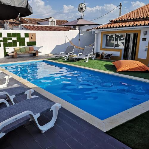a swimming pool in the backyard of a house at Casinhas do Canário in Montoito