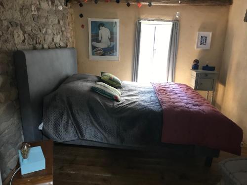 a bedroom with a bed and a window at LA MAISON DU BOSCO in Auray
