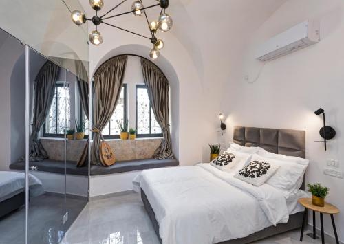a bedroom with a large bed with a glass wall at Old City Boutique Hotel in Jerusalem
