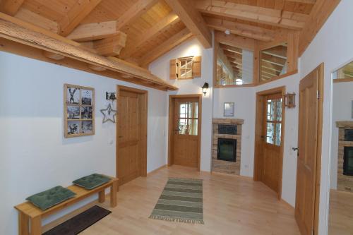 a large room with wooden ceilings and wooden doors at AlpStern Ferienwohnung in Oberstdorf