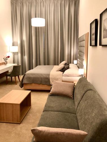 a living room with a couch and a bed at Hrebienok D407 in Starý Smokovec