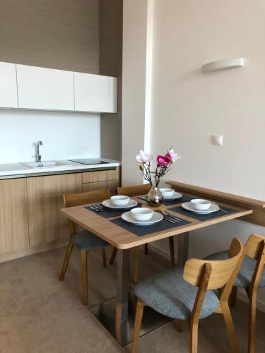a kitchen with a wooden table with chairs and a dining room at Hrebienok D407 in Starý Smokovec