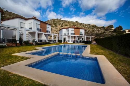 a house with a swimming pool in the yard at Benestar In Jalon Valley in Alcalalí