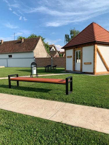 a bench sitting in the grass in a park at Bungalovi Blagojević in Morović
