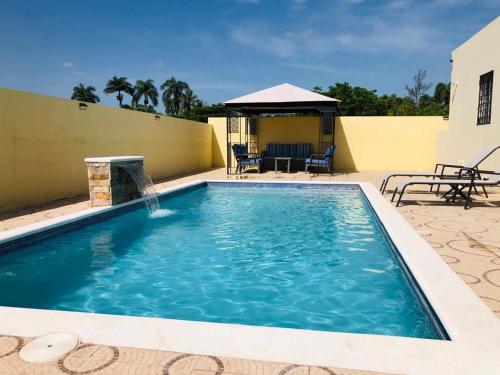 a swimming pool with a fountain and a gazebo at 2bedroom mountain view villa #2 in Muñoz