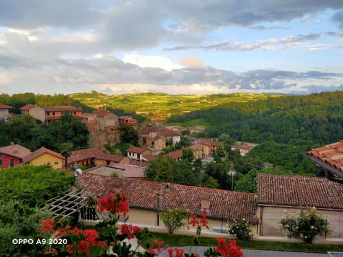 a view of a town with houses and trees at B&B Madonna degli Airali in Vezza d'Alba