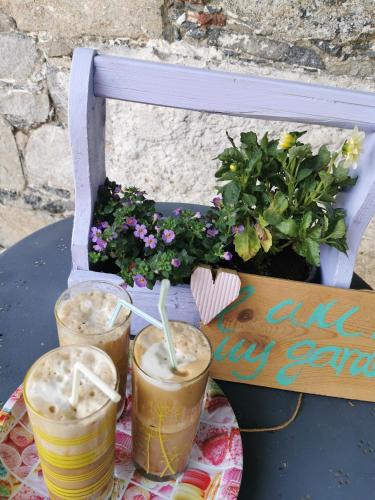 a table with three drinks on a table at Holiday House Prodromos in Prodromos