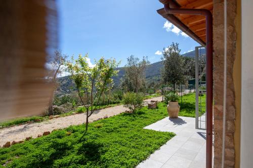 a view of a garden from a house at Borgo dell'Uccellaia - Turchese - Giada in Marciana Marina