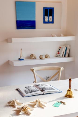 a room with a table with a book and starfish at Almira Hotel in Troulos