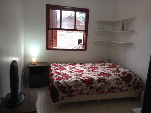 Säng eller sängar i ett rum på Hospedagem dona Tania