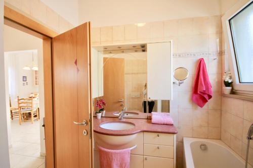 a bathroom with a sink and a toilet and a tub at GardaLake View Villa in Lazise