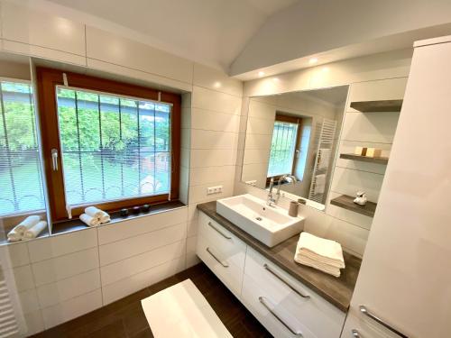 a bathroom with a sink and a mirror at Ferienhaus Karawankenblick in Wurzen