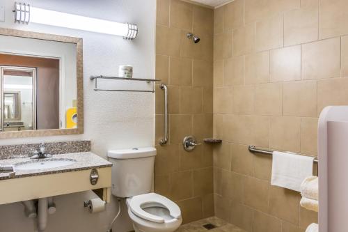 a bathroom with a toilet and a sink and a mirror at Motel 6-Petersburg, VA - Fort Lee in Petersburg