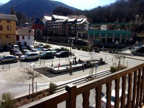 a city with cars parked in a parking lot at Appartement VILLA PAULA Ax-les-Thermes in Ax-les-Thermes