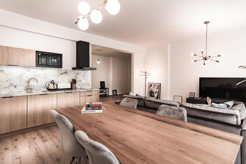 una sala de estar con una gran mesa de madera. en Sleep Inn Wehrhahn Suites, en Düsseldorf