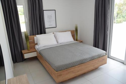 a bedroom with a bed and a window at Tala Luxury apartments with pool by Raise in Tala