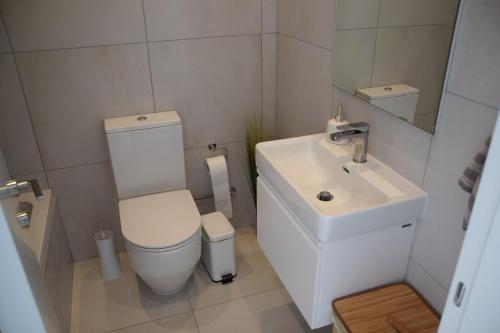a small bathroom with a toilet and a sink at Tala Luxury apartments with pool by Raise in Tala