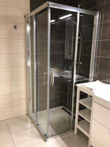 a shower with a glass door in a bathroom at Hrebienok C217 in Starý Smokovec