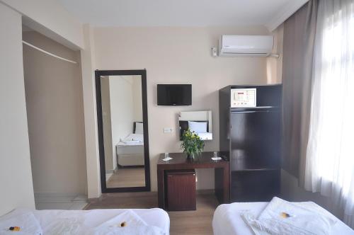 a hotel room with a mirror and a bedroom at Hotel Baykal in Istanbul