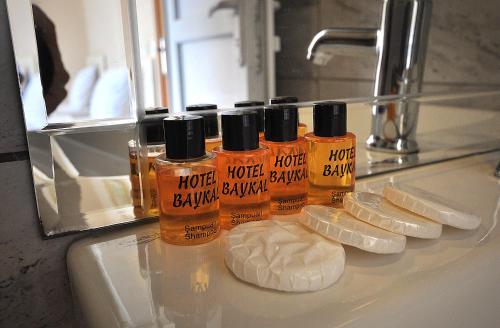 three bottles of honey sitting on a bathroom sink at Hotel Baykal in Istanbul