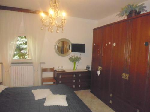 a bedroom with a bed and a dresser and a mirror at A casa di Lara in Beura