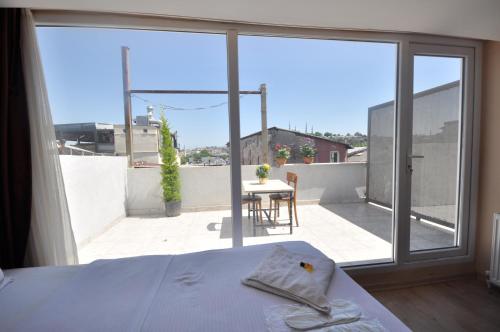 a bedroom with a bed and a view of a balcony at Hotel Baykal in Istanbul