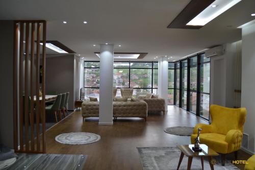 a living room with a couch and chairs and a table at Kuint Hotel in Peje