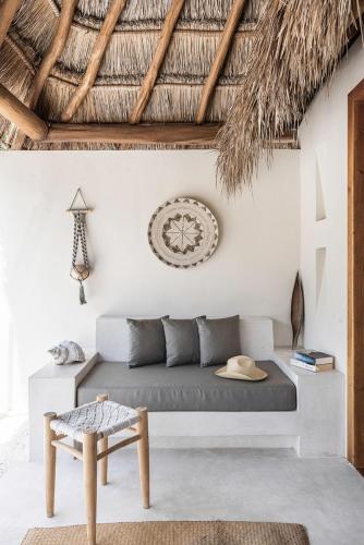 a living room with a couch and a chair at Tierra del Mar Hotel - Adults Only in Holbox Island