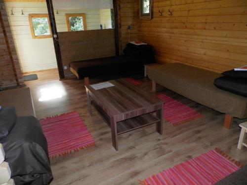 a living room with a couch and a coffee table at Paepealse Guesthouse in Kullamaa
