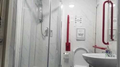 a bathroom with a shower and a sink at City View Hotel Roman Road in London