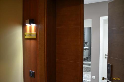 a door with a sign on it next to a room at Kuint Hotel in Peje