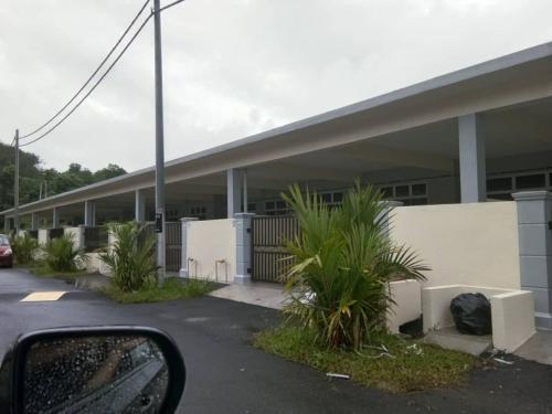 a side view mirror of a building with plants at Ulfah Mersing الفة in Mersing