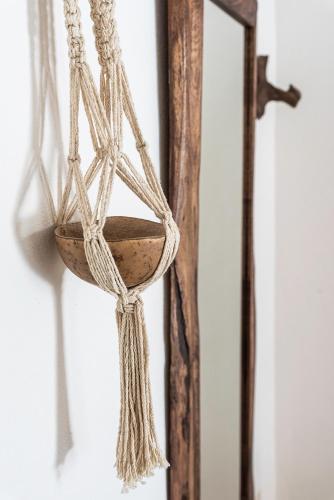 a wooden bowl with rope hanging from a wall at Tierra del Mar Hotel - Adults Only in Holbox Island