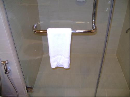 a towel hanging on a shower door in a bathroom at Felda Residence Kuala Terengganu in Kuala Terengganu
