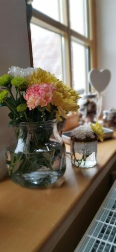 a vase filled with flowers sitting on a table at hotel ZLATÝ POTOK in Nicov