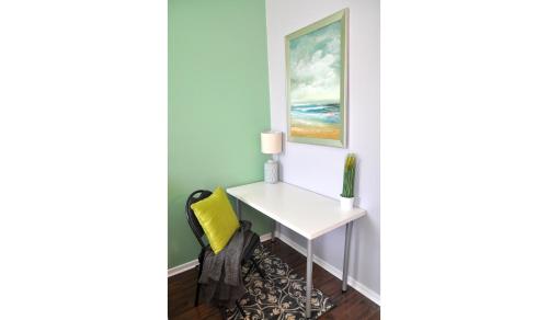 a desk in a corner of a room with a yellow chair at Dream Catcher Travel House in Toronto