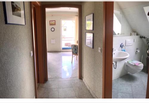 a bathroom with a toilet and a sink at Ferienwohnung Altenkirchen 1 in Altenkirchen