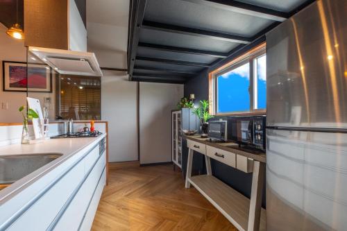 a kitchen with a sink and a counter top at Good Day Hotel in Chatan