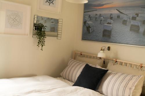 sypialnia z łóżkiem i obrazem na ścianie w obiekcie Lot Lodge Travemünde w Lubece
