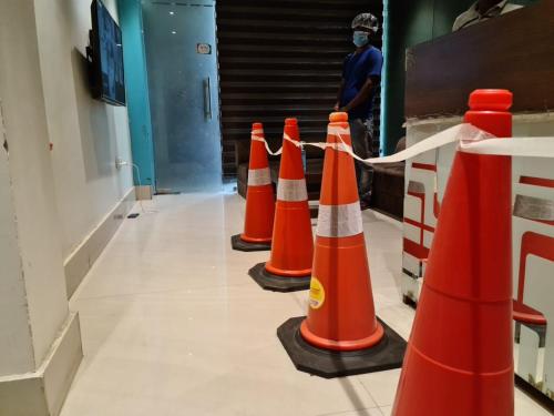 a row of orange traffic cones in a hallway at Hotel Star Inn in Gangānagar