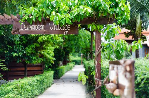 a sign that reads garden village in a garden at Maikaew Damnoen Resort in Damnoen Saduak